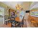 Traditional dining room features a wood table with seating for six and wood floors at 4724 Hopi Rd, Indian Hills, CO 80454