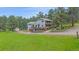 Two-story home with a large yard, multiple decks, and attached garage at 4724 Hopi Rd, Indian Hills, CO 80454