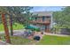 Two story home featuring a deck and patio with seating, bbq, and fireplace at 4724 Hopi Rd, Indian Hills, CO 80454