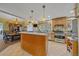 Open floor plan with kitchen featuring stainless steel appliances and tiled floors at 4724 Hopi Rd, Indian Hills, CO 80454