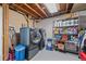 Functional laundry room featuring modern washer and dryer units, plus metal storage shelves at 4724 Hopi Rd, Indian Hills, CO 80454