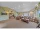 Spacious living room with vaulted ceilings, carpeted floors, and natural light at 4724 Hopi Rd, Indian Hills, CO 80454