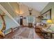 Inviting living room with high ceilings, wood floors, staircase and a comfortable seating area at 4724 Hopi Rd, Indian Hills, CO 80454