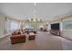 Bright living room with plush sofas, ottoman, and a large flat-screen TV, perfect for relaxation at 4724 Hopi Rd, Indian Hills, CO 80454