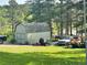 Practical storage shed with ample space for tools and equipment, surrounded by green grass at 4724 Hopi Rd, Indian Hills, CO 80454