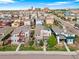 Aerial view of a neighborhood with colorful houses and green lawns, with a view of the city at 3384 Cranston Cir, Highlands Ranch, CO 80126