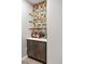 Stylish bar area with custom shelving, ample storage, and unique decorative touches at 3384 Cranston Cir, Highlands Ranch, CO 80126