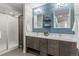 Bathroom with double sink vanity, stylish wall color, mirrors, and a separate shower at 3384 Cranston Cir, Highlands Ranch, CO 80126