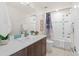 Well-lit bathroom with a modern sink vanity, decorative mirror, and shower-tub combo at 3384 Cranston Cir, Highlands Ranch, CO 80126