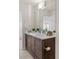 Stylish bathroom featuring a dark wood vanity, white countertop, and decor at 3384 Cranston Cir, Highlands Ranch, CO 80126