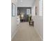 A hallway leads to a bedroom with a grey accent wall and plantation shutters at 3384 Cranston Cir, Highlands Ranch, CO 80126
