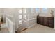 Hallway landing featuring white railings and a dark wood cabinet at 3384 Cranston Cir, Highlands Ranch, CO 80126