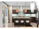 Elegant kitchen with modern copper pendant lighting, a center island, and an open layout with an adjacent dining area at 3384 Cranston Cir, Highlands Ranch, CO 80126