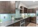 Modern kitchen features stainless steel appliances, sleek cabinetry, and a stylish backsplash at 3384 Cranston Cir, Highlands Ranch, CO 80126