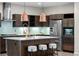 Gourmet kitchen with sleek cabinetry, stainless steel appliances, and a spacious island with breakfast bar seating at 3384 Cranston Cir, Highlands Ranch, CO 80126