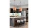 Chic kitchen features a stylish island, copper pendant lights, and modern amenities perfect for cooking and entertaining at 3384 Cranston Cir, Highlands Ranch, CO 80126