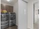 Convenient laundry area featuring a modern washer and dryer set, and storage cabinets at 3384 Cranston Cir, Highlands Ranch, CO 80126