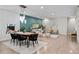 Open concept living room, seamlessly connecting the dining and seating areas, with many decor elements at 3384 Cranston Cir, Highlands Ranch, CO 80126
