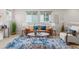 Bright living room featuring a cozy seating arrangement, a stylish rug, and natural light at 3384 Cranston Cir, Highlands Ranch, CO 80126