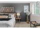 Relaxing main bedroom featuring a grey accent wall and natural decorations at 3384 Cranston Cir, Highlands Ranch, CO 80126