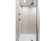 Modern shower with white tiled walls, dual shower heads, and glass door at 3384 Cranston Cir, Highlands Ranch, CO 80126