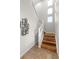 Bright staircase features wood stairs, white railings, and an abstract art piece at 3384 Cranston Cir, Highlands Ranch, CO 80126