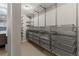 Organized walk-in closet featuring wire shelving and multiple metal sliding storage drawers at 3384 Cranston Cir, Highlands Ranch, CO 80126