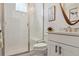 Bright bathroom featuring tile shower, marble vanity, and framed mirror at 10534 Oncilla Ln, Lone Tree, CO 80124