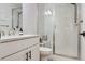 A modern bathroom featuring white subway tiles in shower, a toilet, and vanity with dark hardware at 10534 Oncilla Ln, Lone Tree, CO 80124