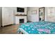Bedroom with fireplace, large dresser, TV, and view into bathroom at 10534 Oncilla Ln, Lone Tree, CO 80124