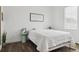 Bright bedroom with white walls and hardwood floors with minimalist decor at 10534 Oncilla Ln, Lone Tree, CO 80124