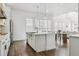 Bright and airy kitchen featuring a center island with seating, pendant lighting, and hardwood floors at 10534 Oncilla Ln, Lone Tree, CO 80124
