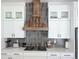 Modern kitchen with white cabinetry, stylish backsplash, and stainless steel appliances at 10534 Oncilla Ln, Lone Tree, CO 80124
