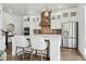 Modern kitchen with white cabinets, stainless steel appliances, a center island with bar seating, and pendant lighting at 10534 Oncilla Ln, Lone Tree, CO 80124