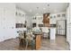 Open kitchen features a large island, stainless steel appliances, pendant lighting, and a spacious dining area at 10534 Oncilla Ln, Lone Tree, CO 80124