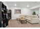 A cozy living room with a comfortable sectional couch, coffee table, and stylish decor at 10534 Oncilla Ln, Lone Tree, CO 80124
