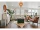 Bright living room with decorative chandelier, hardwood floors, and comfortable seating at 10534 Oncilla Ln, Lone Tree, CO 80124