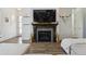 Inviting living room with a stone fireplace, a large TV and a cozy sitting arrangement at 10534 Oncilla Ln, Lone Tree, CO 80124