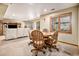 View of a cozy finished basement with a dining table and chairs, along with a sectional couch and built-in entertainment center at 5542 Ponderosa Dr, Parker, CO 80134