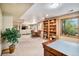 Finished basement area with living space, dining table, and shelving, offering a comfortable retreat at 5542 Ponderosa Dr, Parker, CO 80134