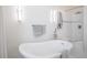 Relaxing bathroom featuring a freestanding tub, elegant lighting, and neutral color palette at 5542 Ponderosa Dr, Parker, CO 80134
