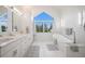 Bright bathroom featuring a large window, double sinks and a luxurious soaking tub at 5542 Ponderosa Dr, Parker, CO 80134