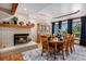 Well-lit dining room features a fireplace, display cabinet, and a large dining table and chairs at 5542 Ponderosa Dr, Parker, CO 80134