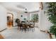 Dining room with a round table, chairs, and a view of the backyard through large windows at 5542 Ponderosa Dr, Parker, CO 80134