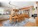 Formal dining room features a large table, hardwood floors, and an open view of the kitchen at 5542 Ponderosa Dr, Parker, CO 80134