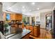 Open kitchen with granite countertops, wood cabinets, an island, and stainless steel appliances at 5542 Ponderosa Dr, Parker, CO 80134