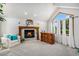 Bright living room with a fireplace, vaulted ceilings, large windows, and a decorative bar area at 5542 Ponderosa Dr, Parker, CO 80134