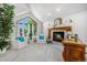 Cozy living room with a stunning fireplace, elegant furniture, and beautiful natural light at 5542 Ponderosa Dr, Parker, CO 80134