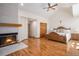 Spacious bedroom with a fireplace, vaulted ceiling, and hardwood floors with a beautifully crafted, wooden bed at 5542 Ponderosa Dr, Parker, CO 80134