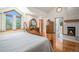 Bright, luxurious main bedroom featuring a fireplace, hardwood floors, and large windows at 5542 Ponderosa Dr, Parker, CO 80134